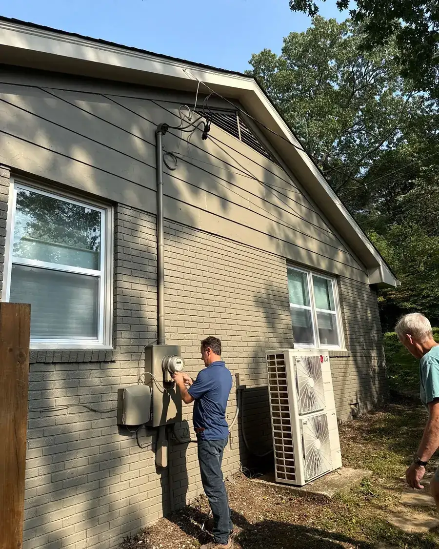 Two Peaceful Painting crew members working together on an exterior