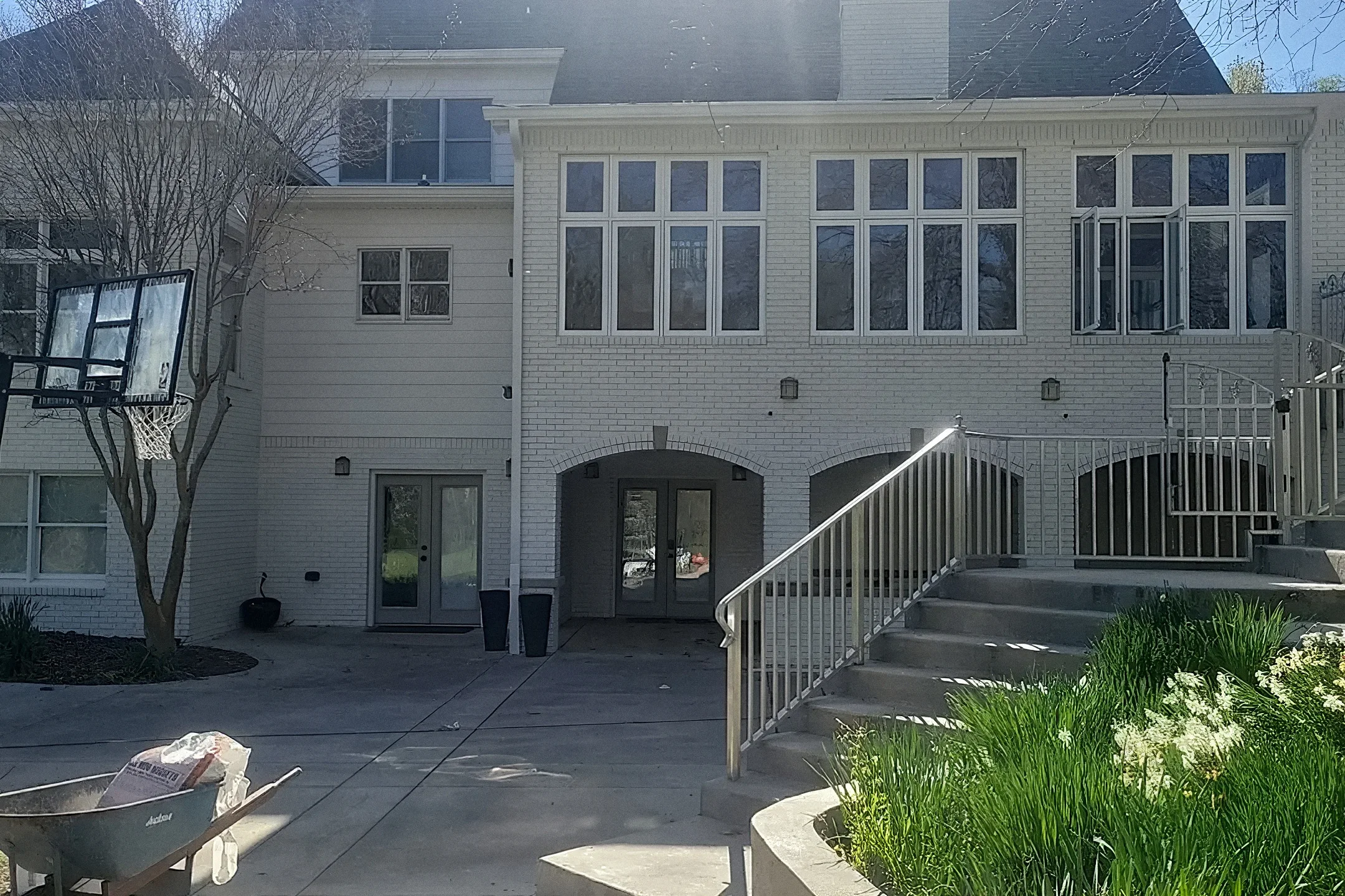 Brick house in Hixson, the same elevation before and after the brick was painted white