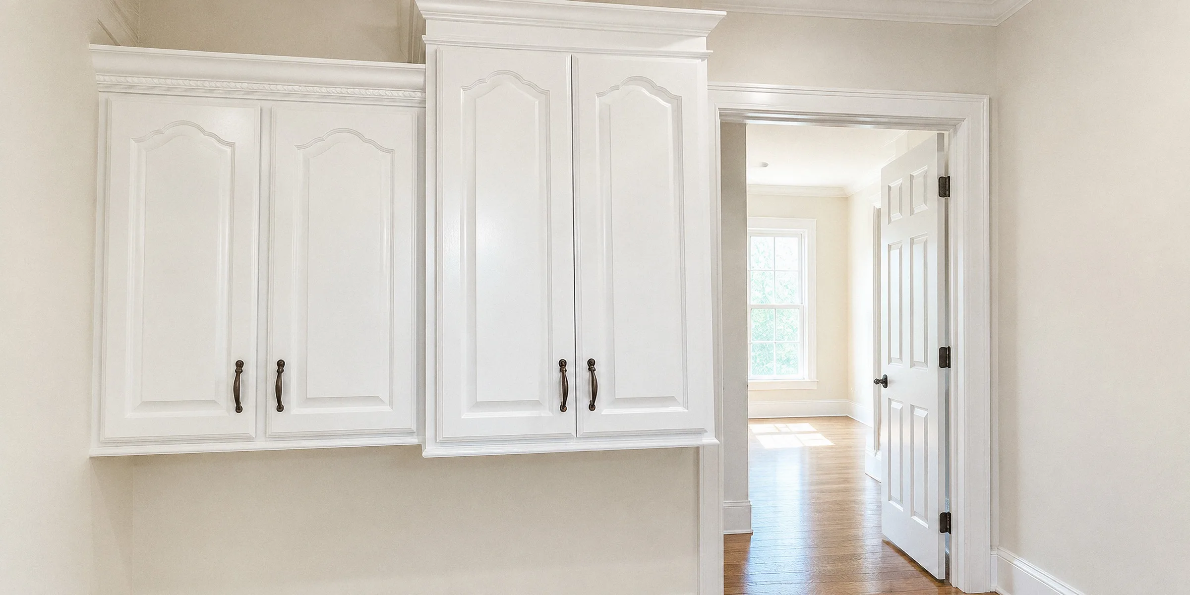 A finished hallway with freshly painted walls and crisp white trim