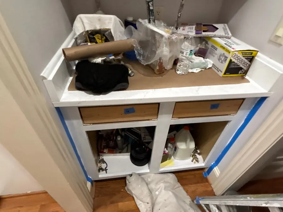 Cabinet boxes masked and the contents wrapped before painting