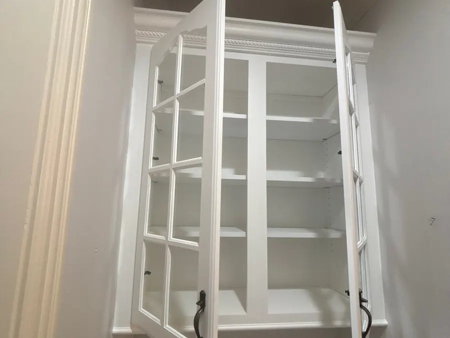 A refinished white built-in bookshelf