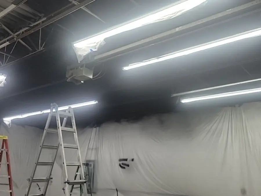 A commercial interior mid-project with ladders in place