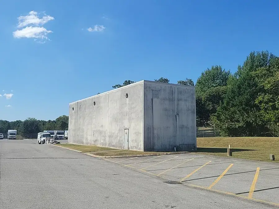 A warehouse exterior in bare weathered concrete block before painting