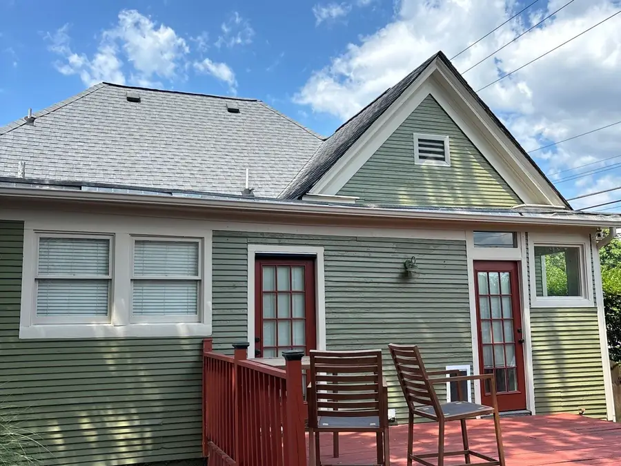 The finished house exterior with a deck