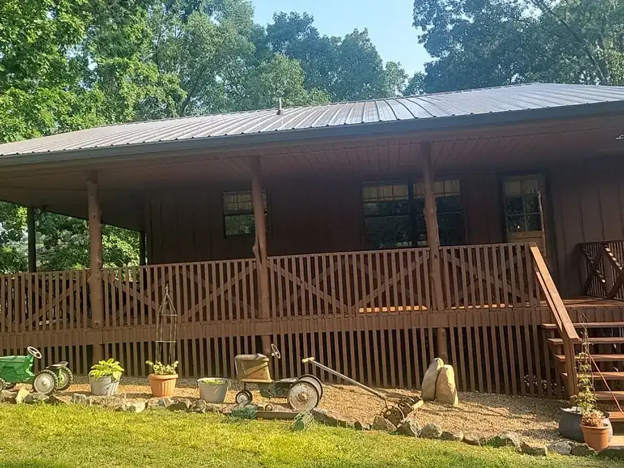 A wood-sided house with a stained porch