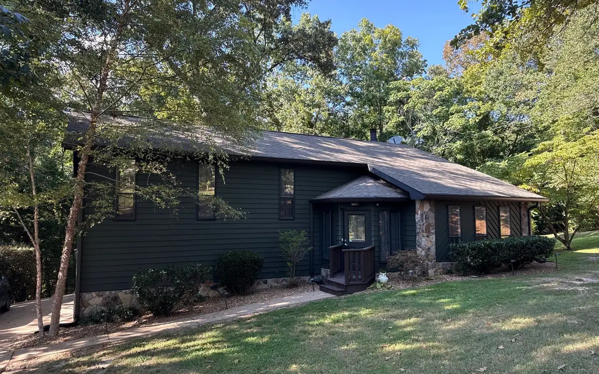 A repainted home exterior in East Brainerd, finished in a dark green