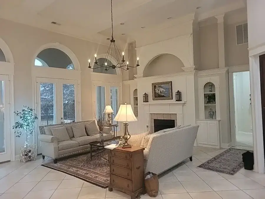 A finished living room with repainted walls, trim and ceiling